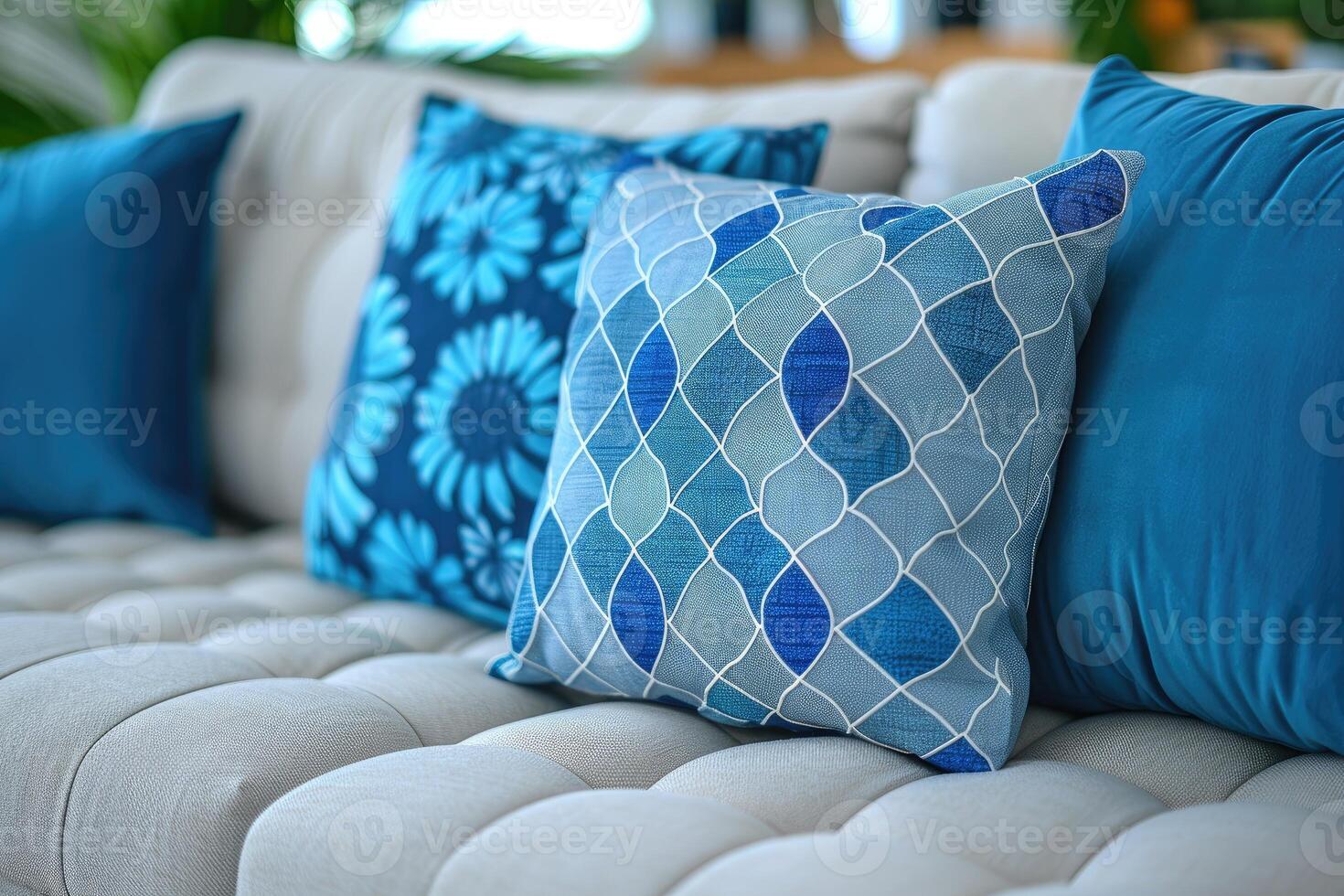 Blue and White Patterned Pillows on a White Couch photo