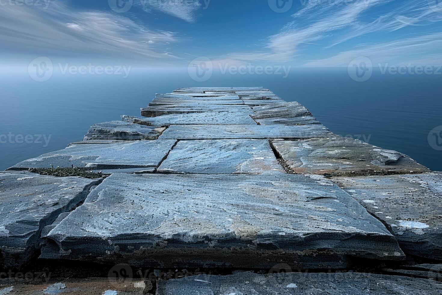 A Crumbling Stone Pathway Extending into the Mist-Covered Sea photo