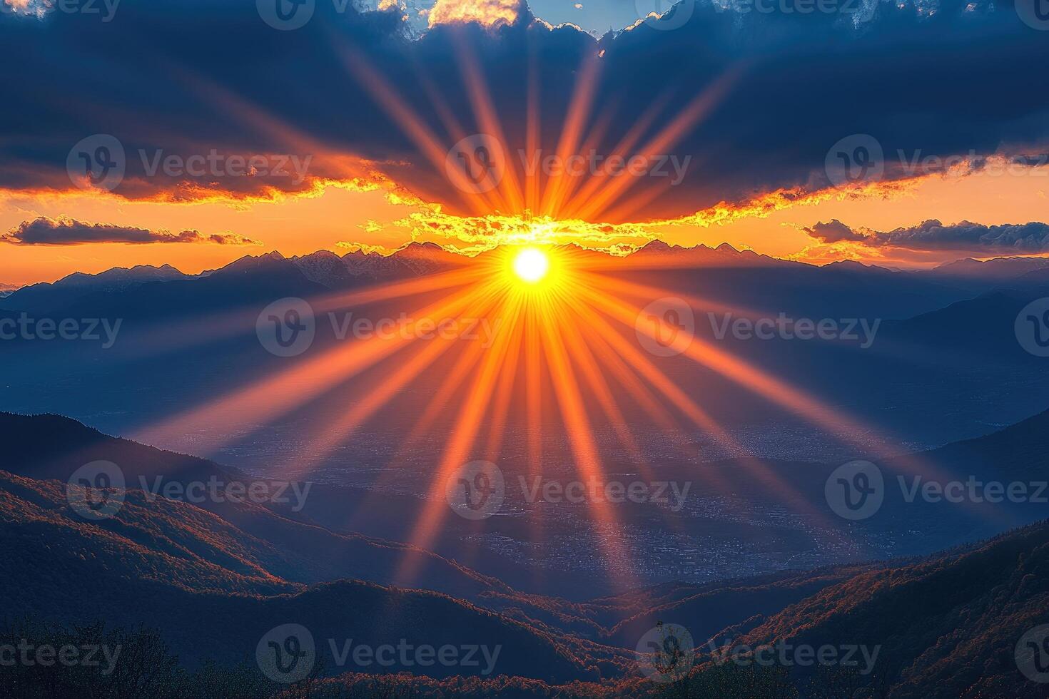 A Mountainous Sunset with Sun Rays Breaking Through Clouds photo