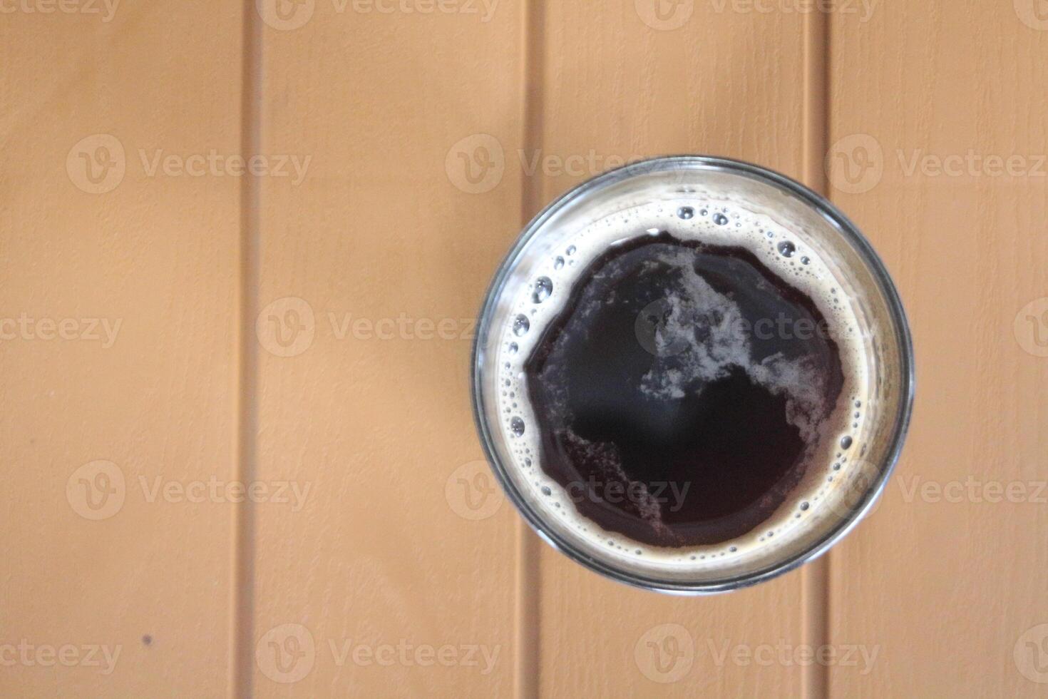 A cup of coffee on a wooden table photo