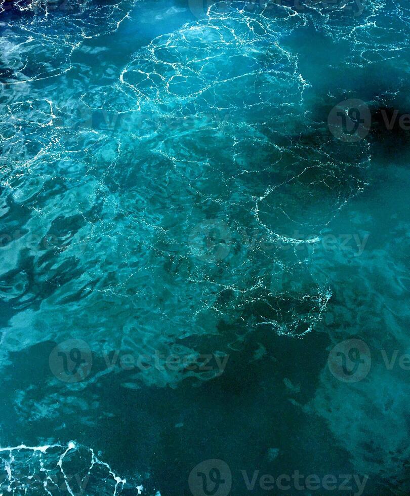 A blue ocean with waves and ripples photo