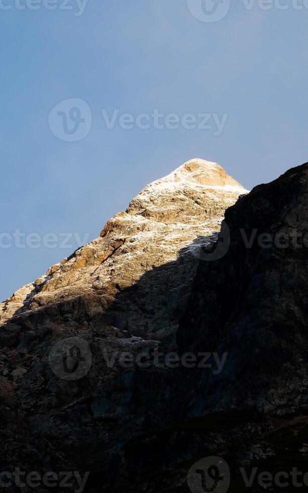 A mountain with a snow covered peak photo