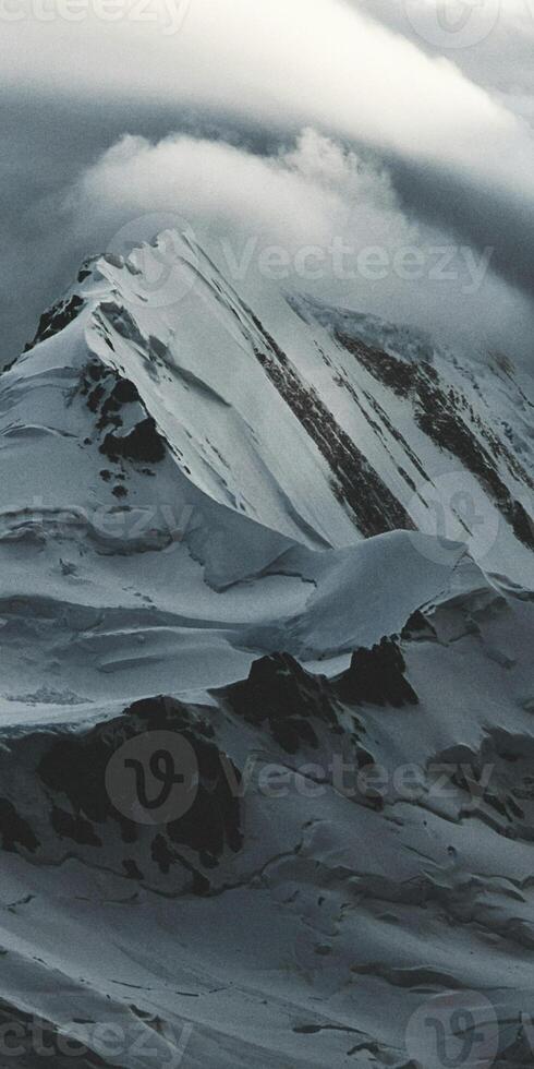 A person on a snowboard is riding down a mountain photo