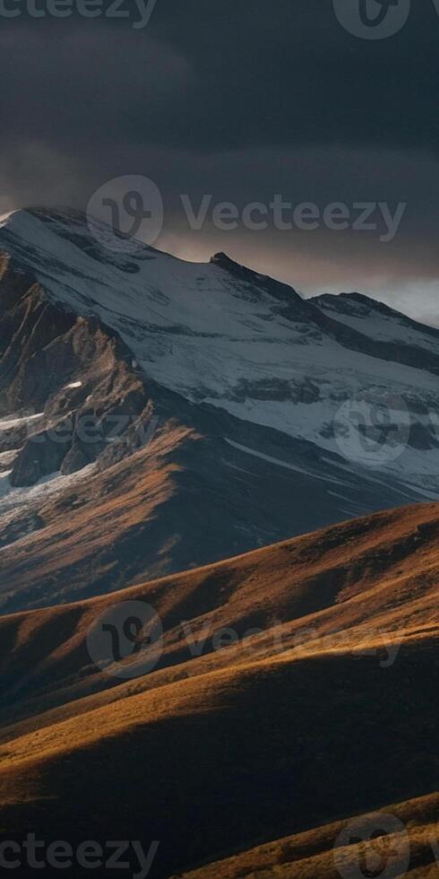 A mountain range with snow capped peaks in the background photo