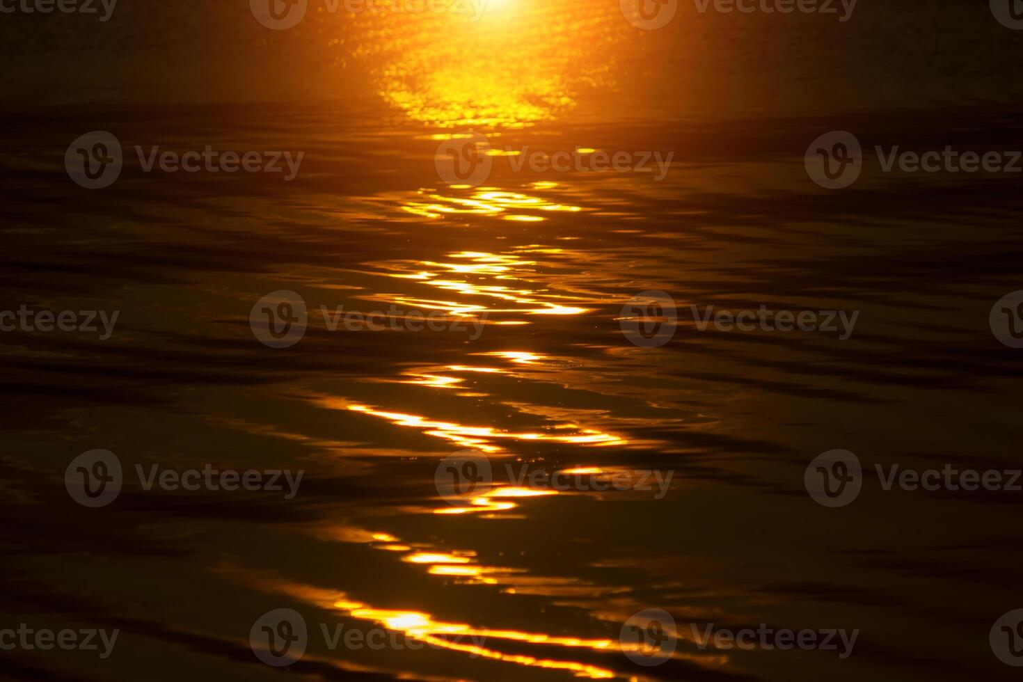 Defocus Water surface images reflect the sunlight at the lake in golden time photo