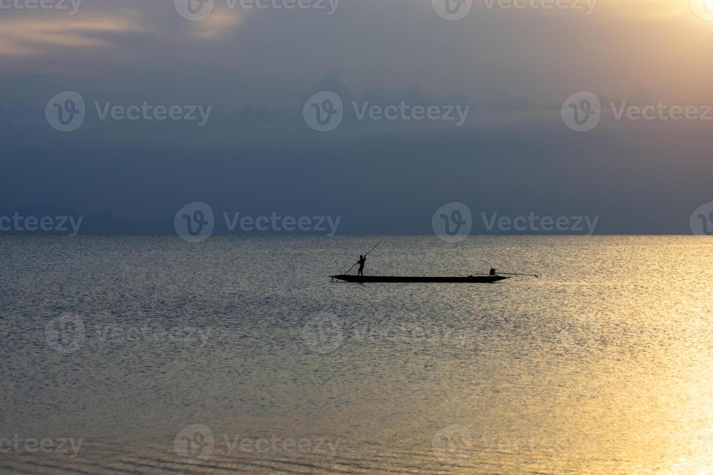 Minimal silhouette fishermans on the lake with twilight sky. photo