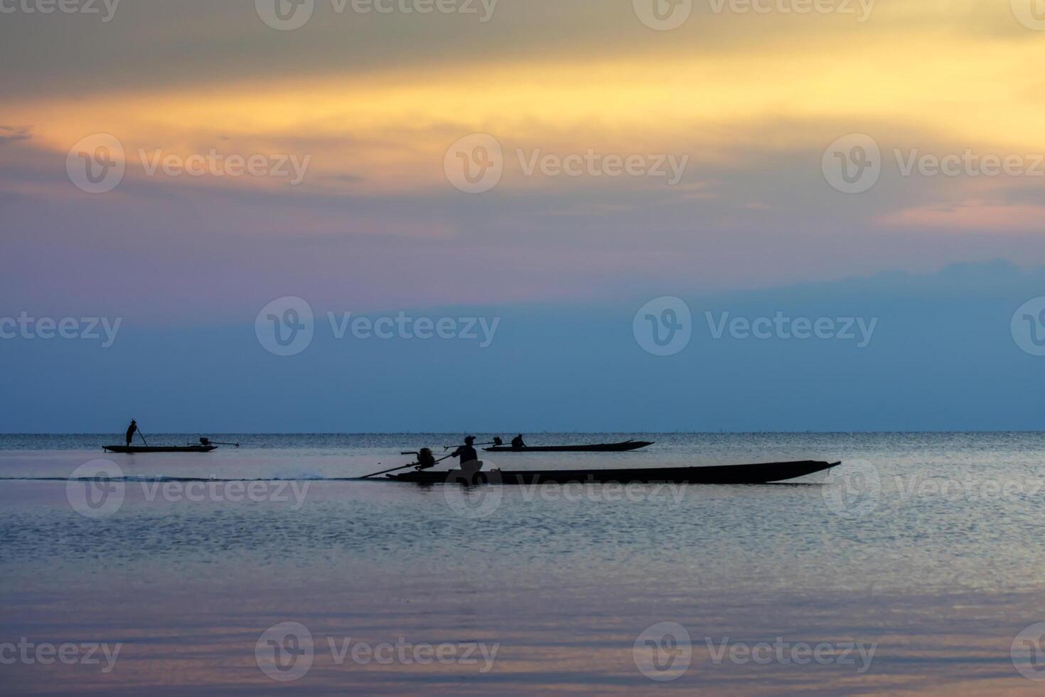 silhouette fishermans on the lake with twilight sky. photo
