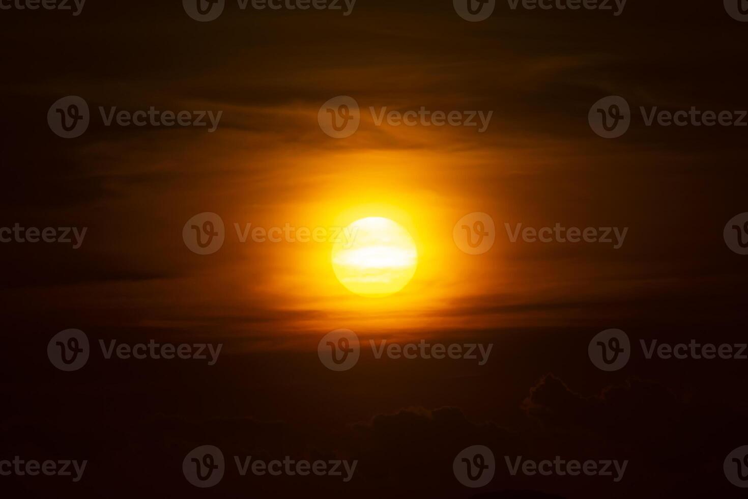 Big sun on Sunset sky with dark clouds. photo