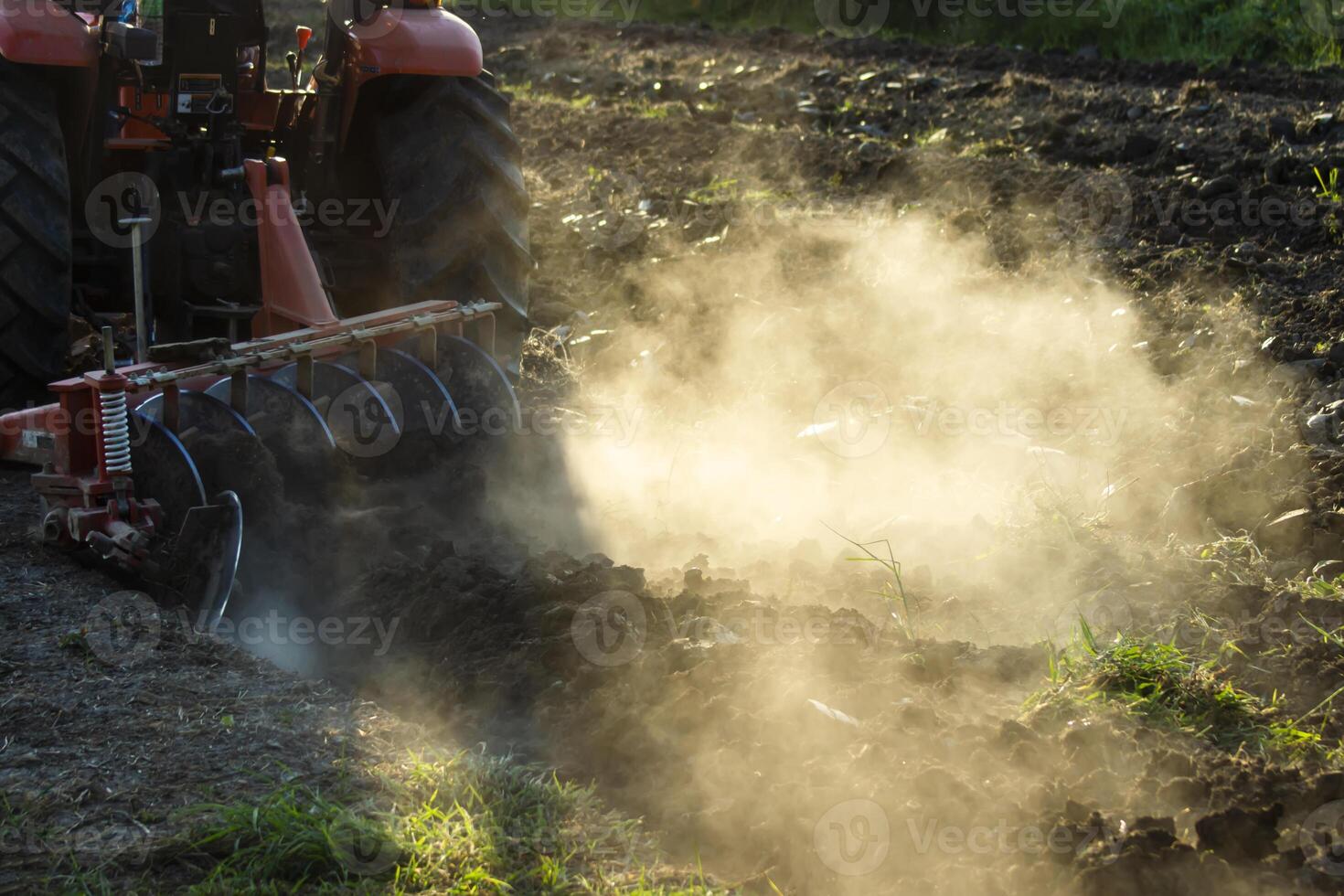 Dust and plowed land with sunlight in farmland photo
