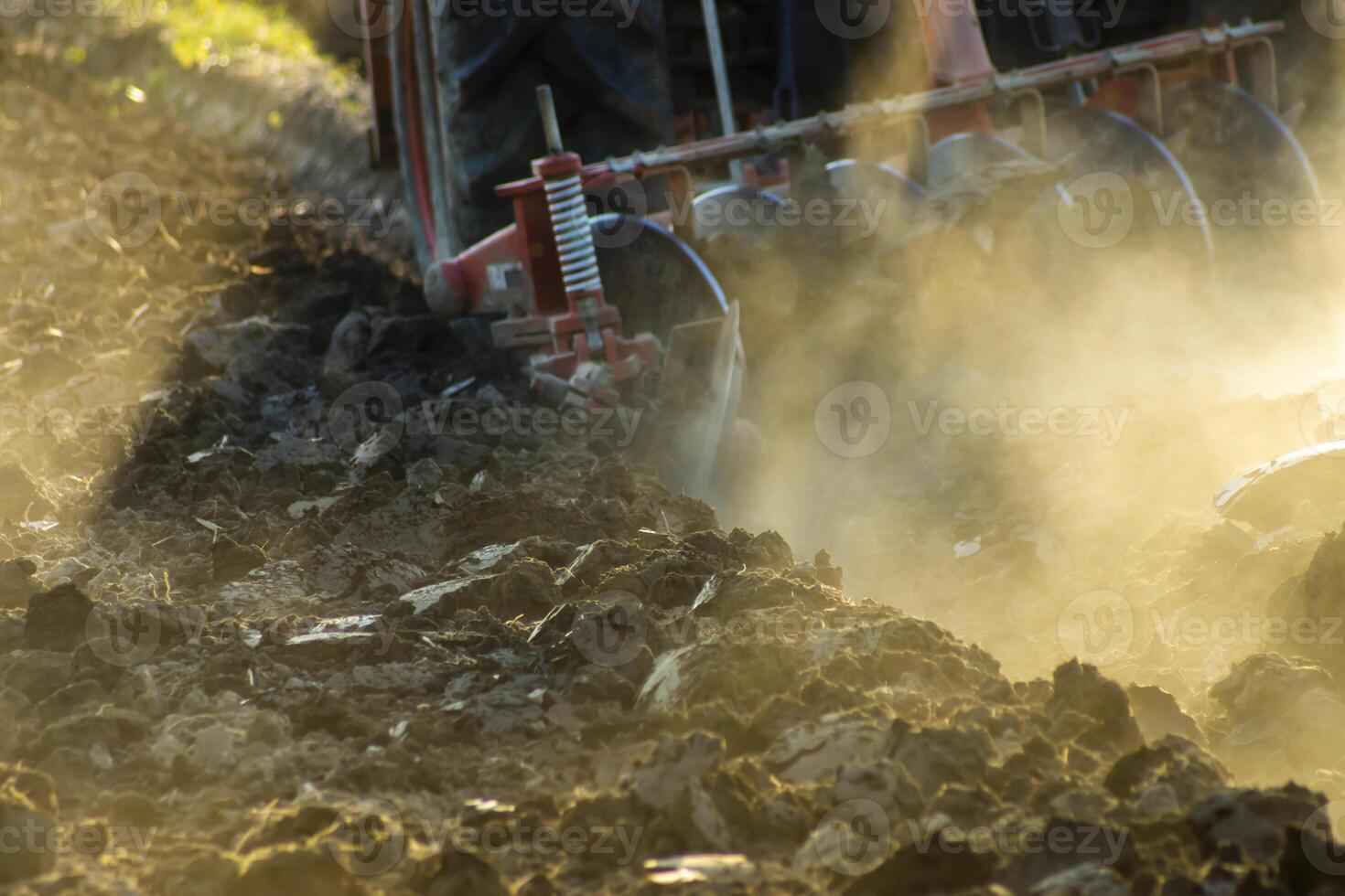 Dust and plowed land with sunlight in farmland photo