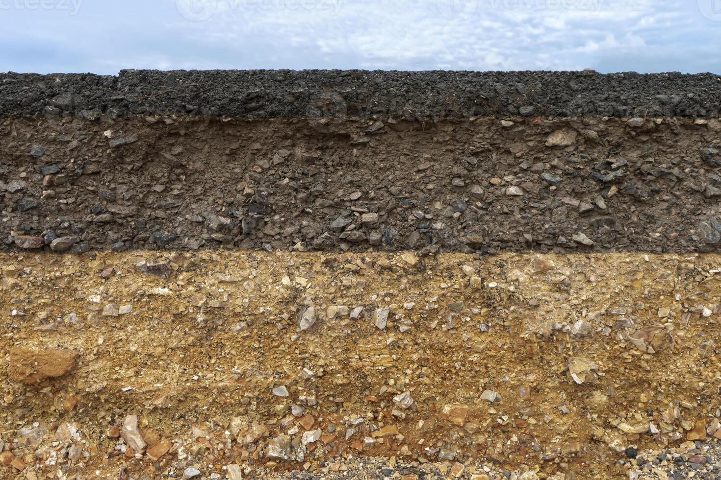The layer of asphalt road with soil and rock. photo