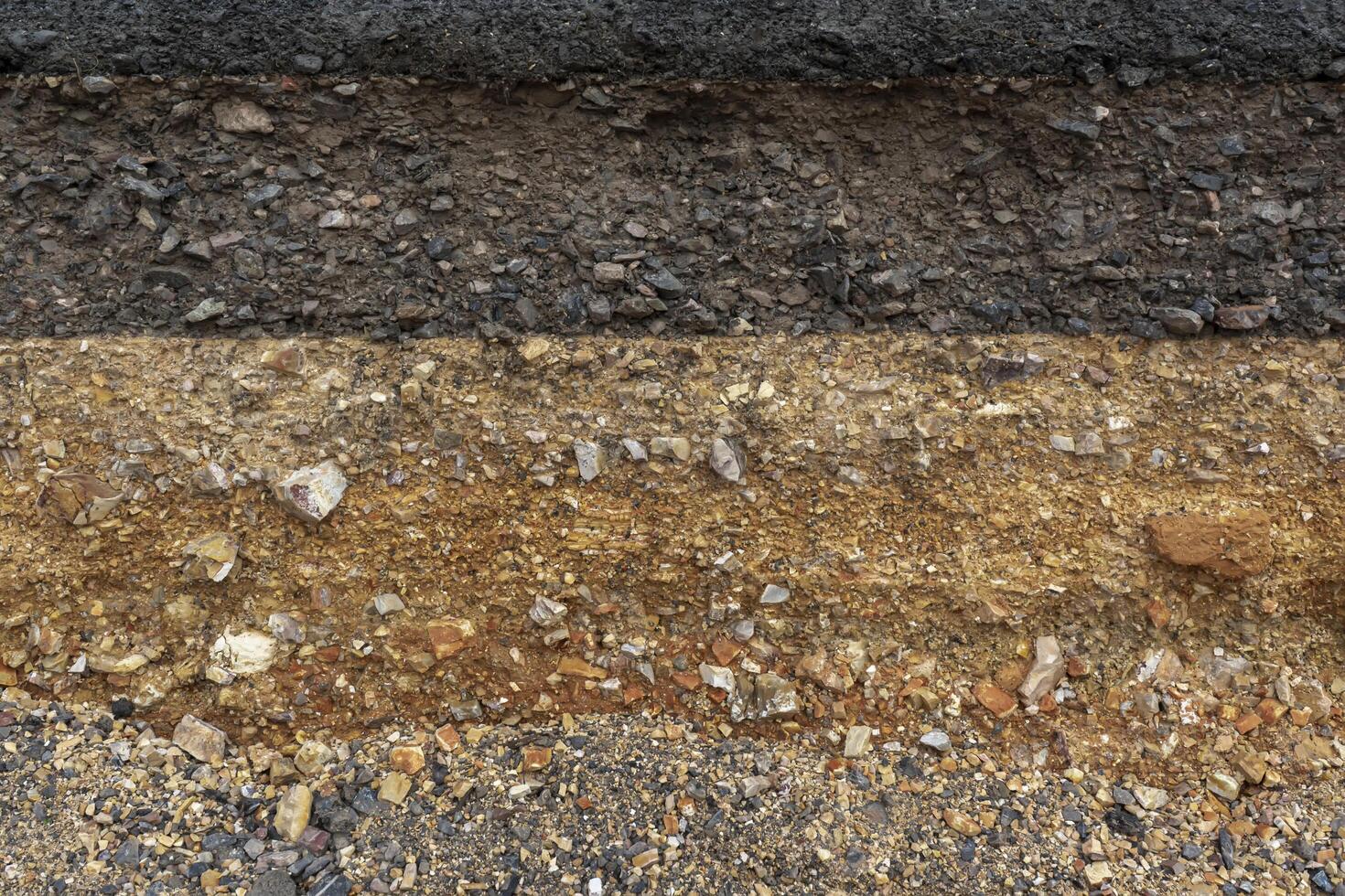 The layer of asphalt road with soil and rock. photo