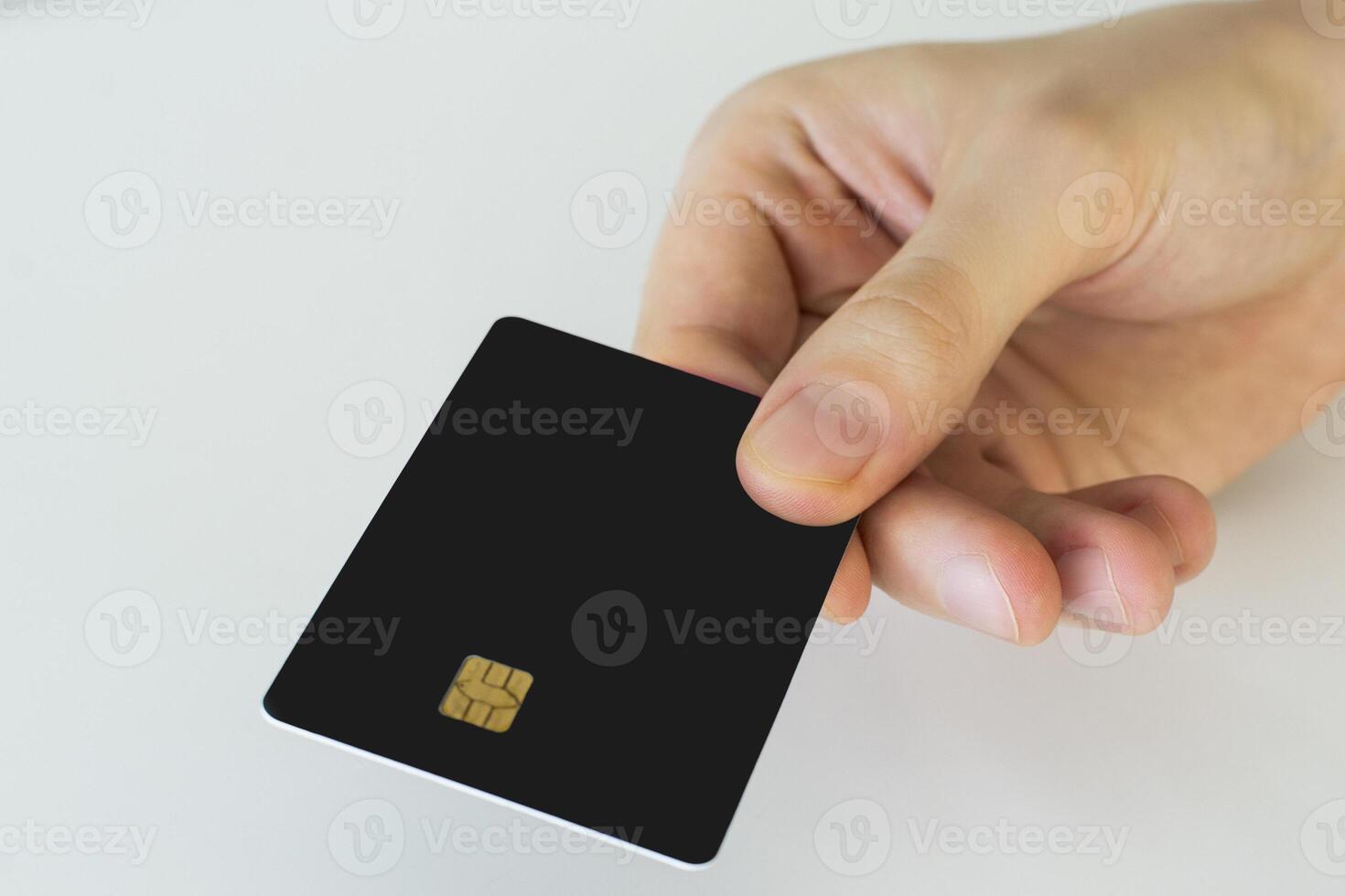 Hand holding credit card, or card, or business card or voucher, isolated on white background, template, mock-up photo