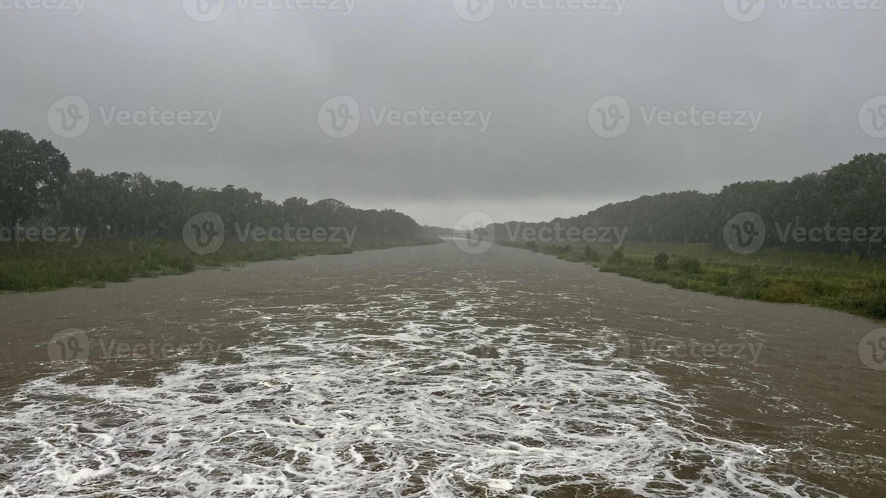 Flowing stream of dirty water in the river, river filled with dirty water after flood. Oder River, Poland photo