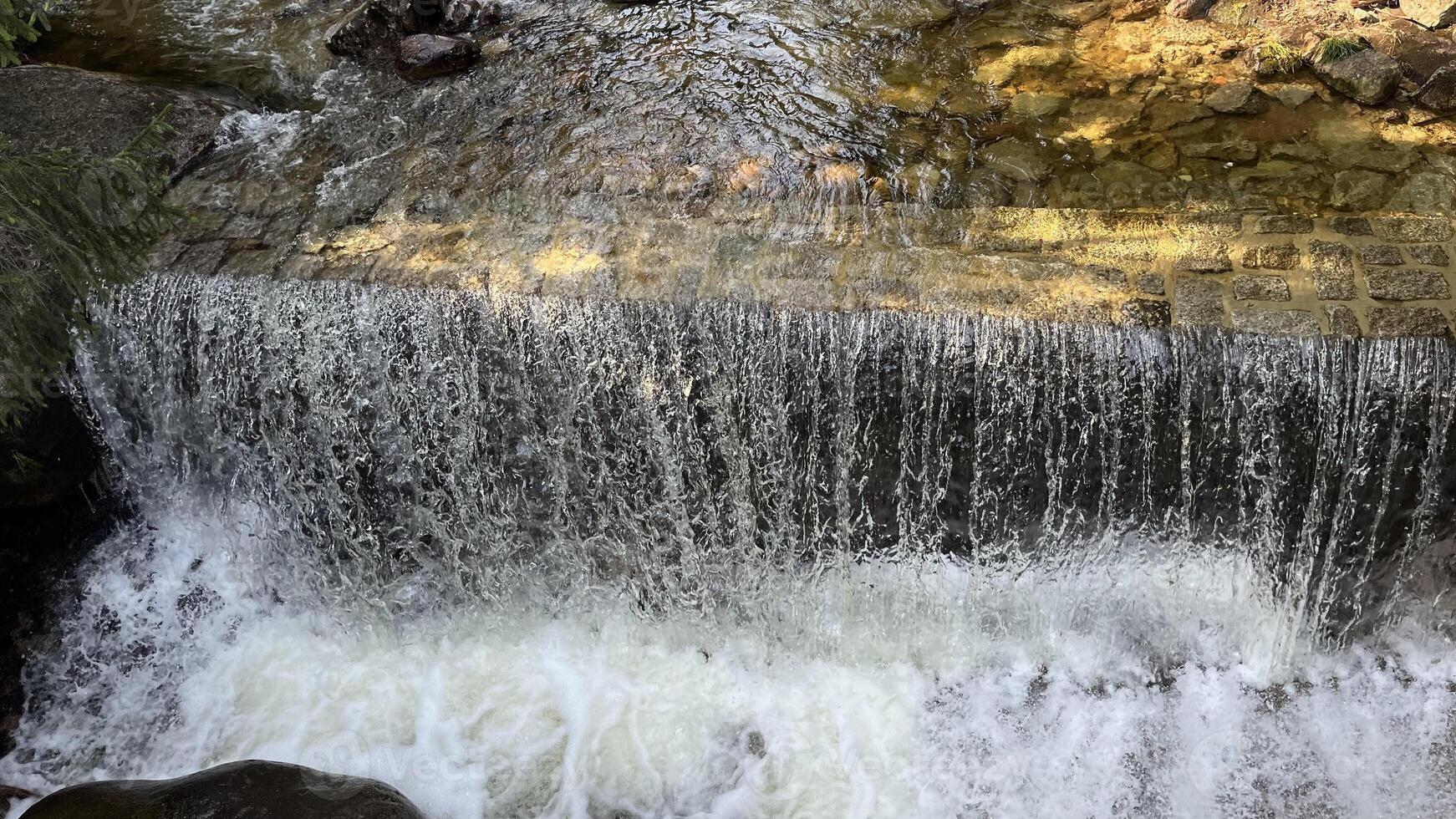 A small mountain river with a flow of water in the Polish mountains. Eastern Sudetes photo