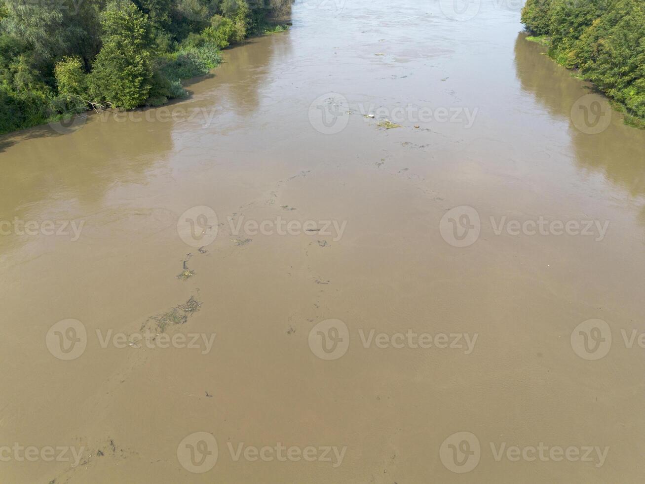 Mudflow of water in the Oder River of brown color. Poland. View from above. Background. photo