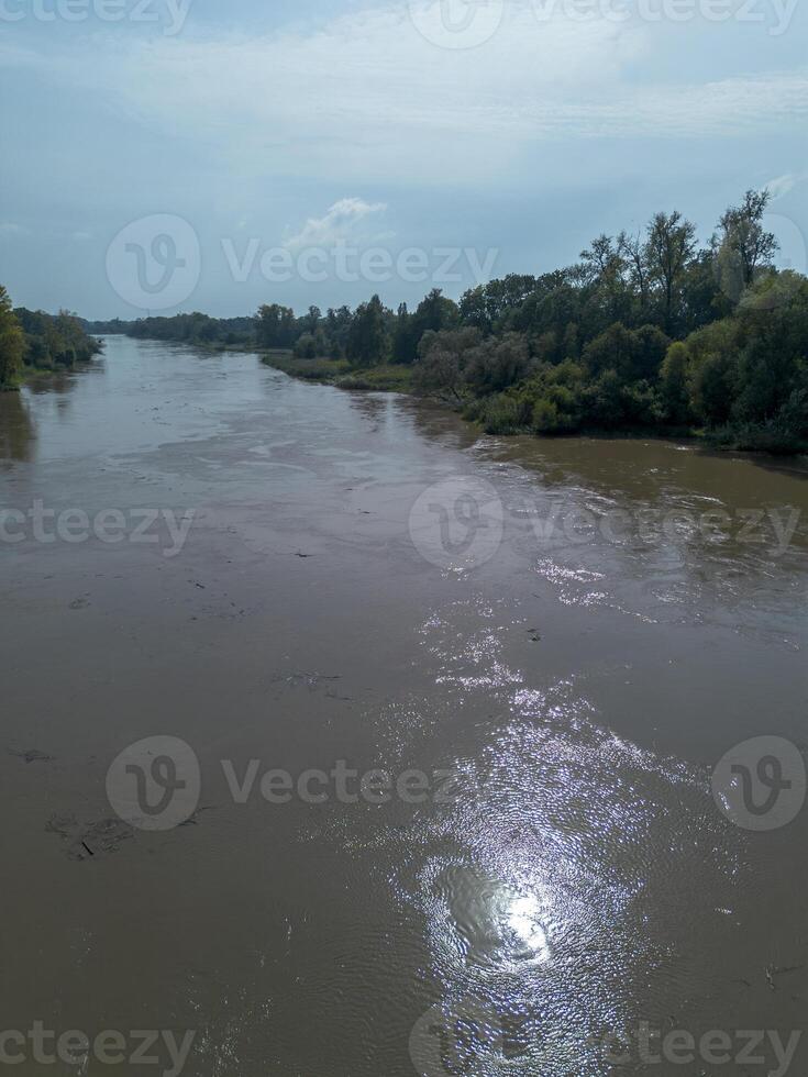 Mudflow of water in the Oder River of brown color. Poland. View from above. Background. photo