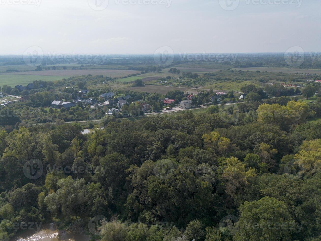 Autumn landscape of forest with field and city. View from above. photo