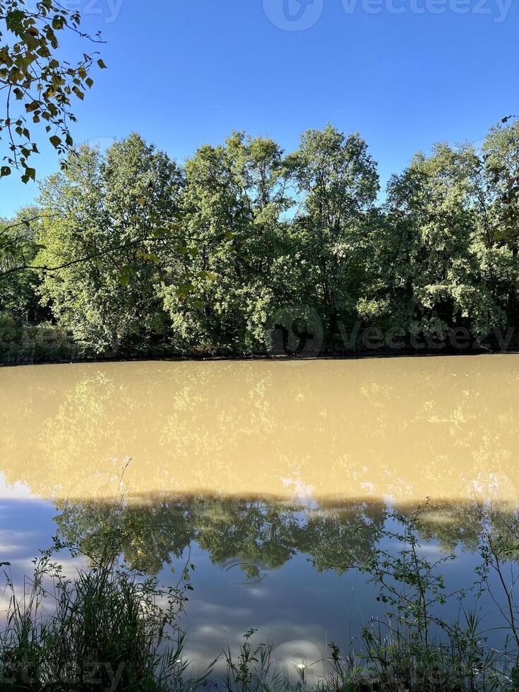 Flowing stream of dirty water in the river, river filled with dirty water after flood. Oder River, Poland photo