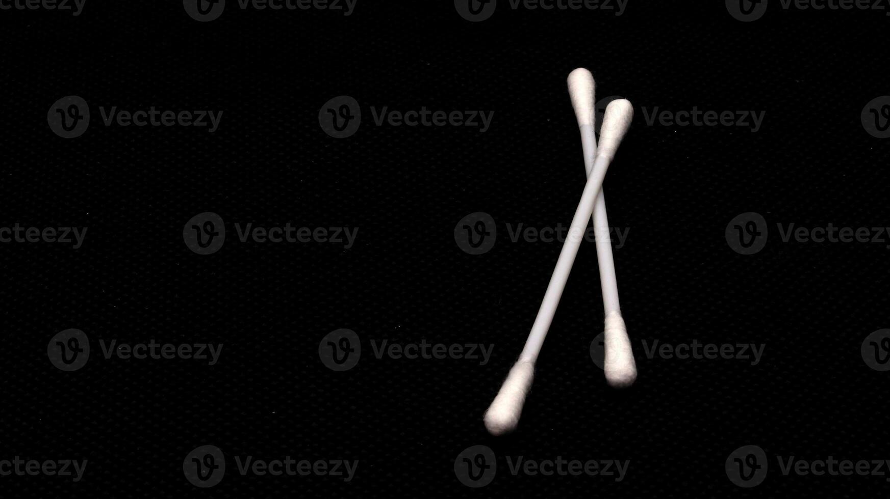 Cotton swabs isolated on black background photo