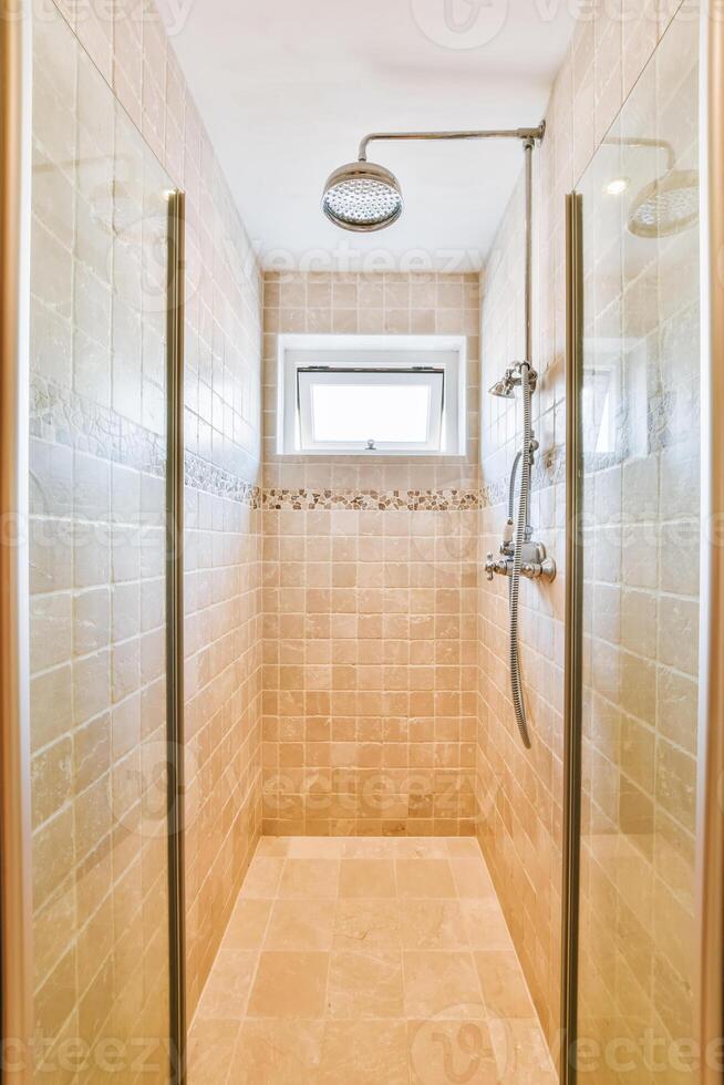 A walk in shower with a window and a toilet photo