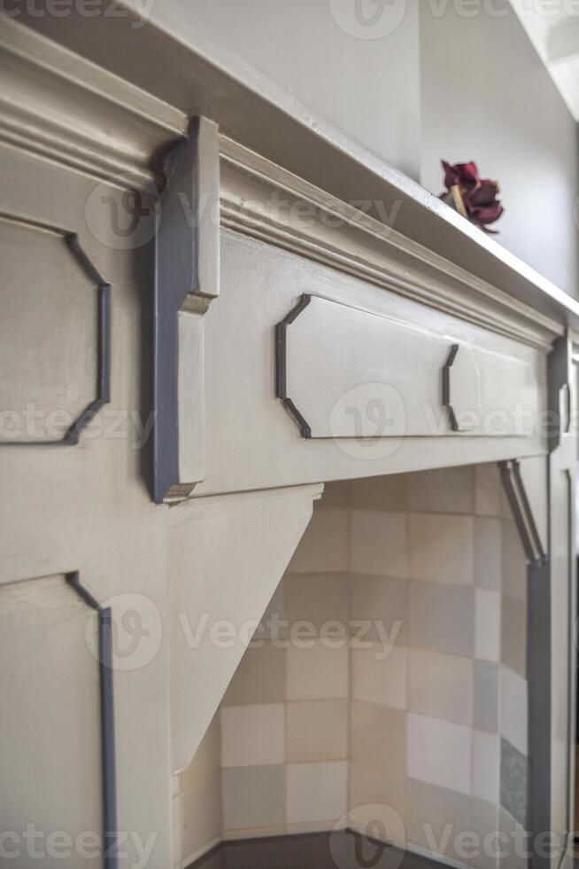 A fireplace with a mantle and a vase on top photo