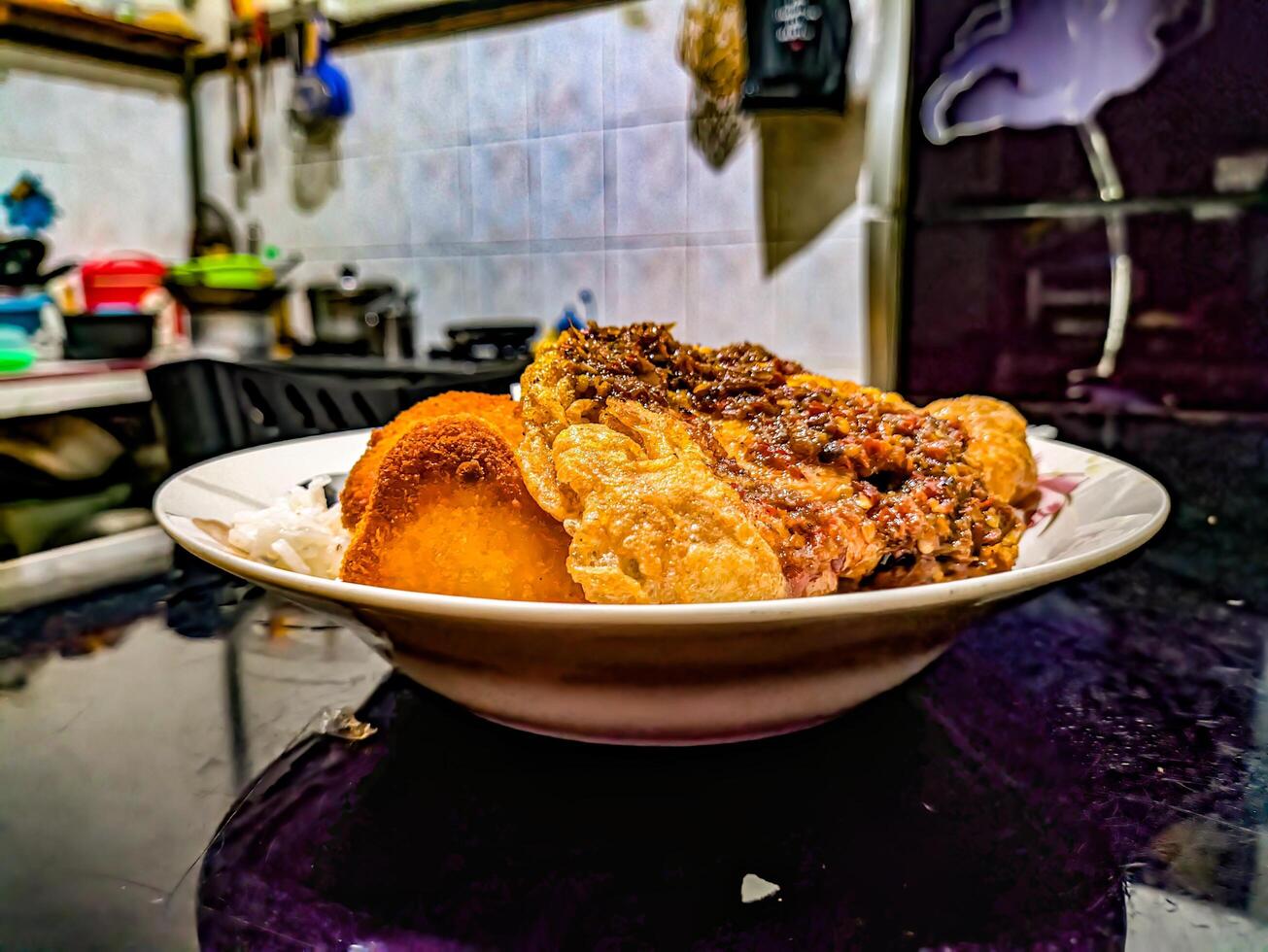 Delicious plate of fried egg rice with sambal, served with utensils, showcasing a popular and simple Asian dish photo