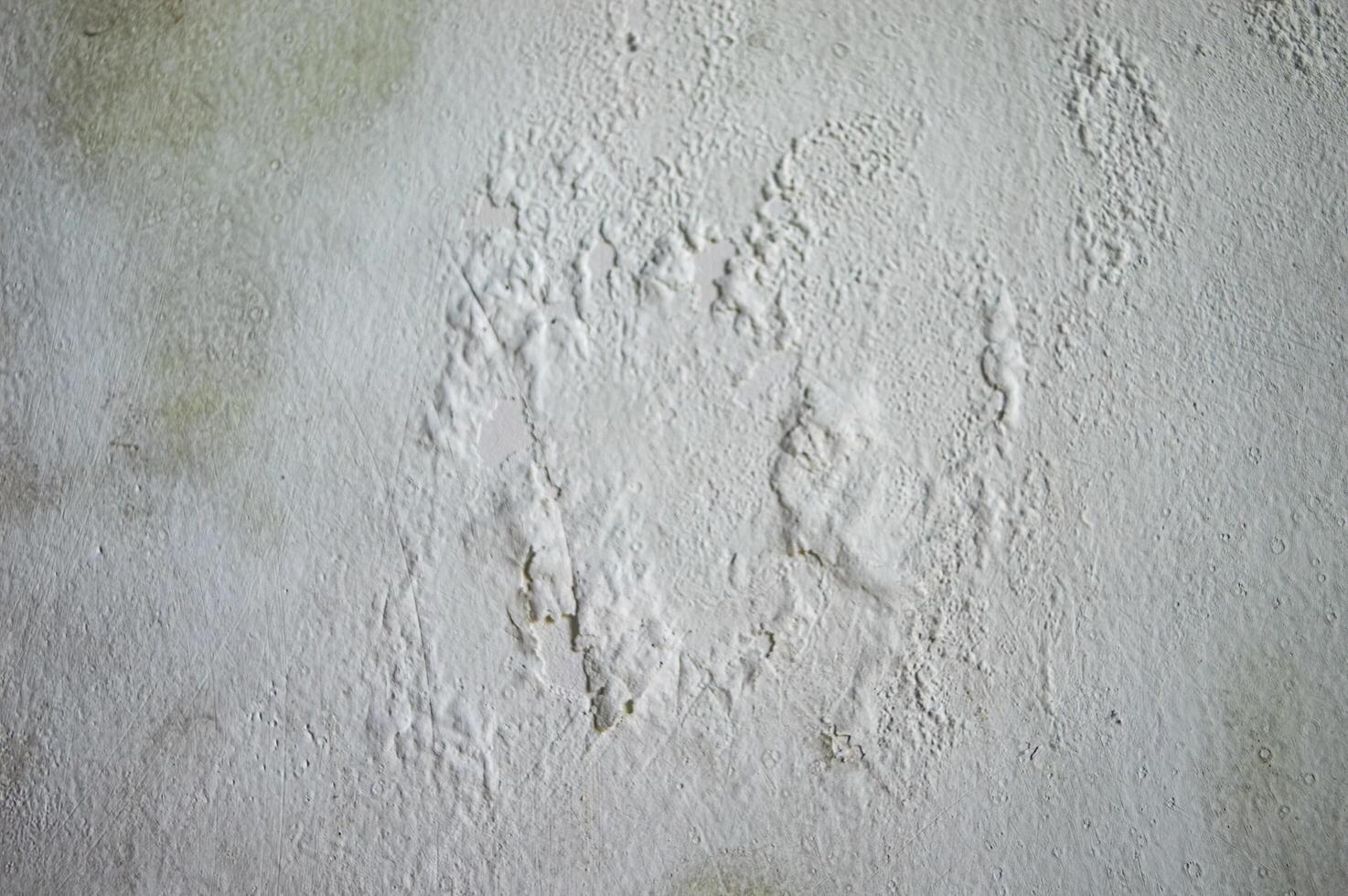 Close up of aged white wall texture with peeling paint and visible wear perfect for background or design element photo