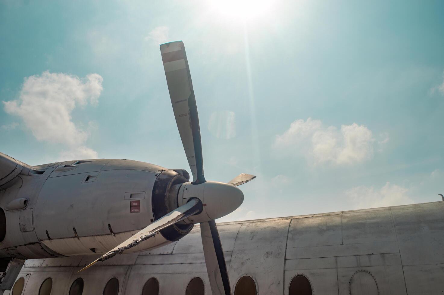 Close up of an airplane propeller against a blue sky with clouds, showcasing detailed aviation engineering and design, Surabaya, 22 September 2024. photo