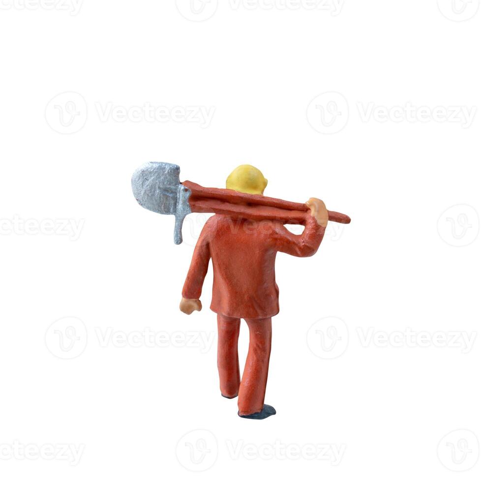 Miniature worker with a shovel slung over his shoulder. isolate on white background with clipping path photo