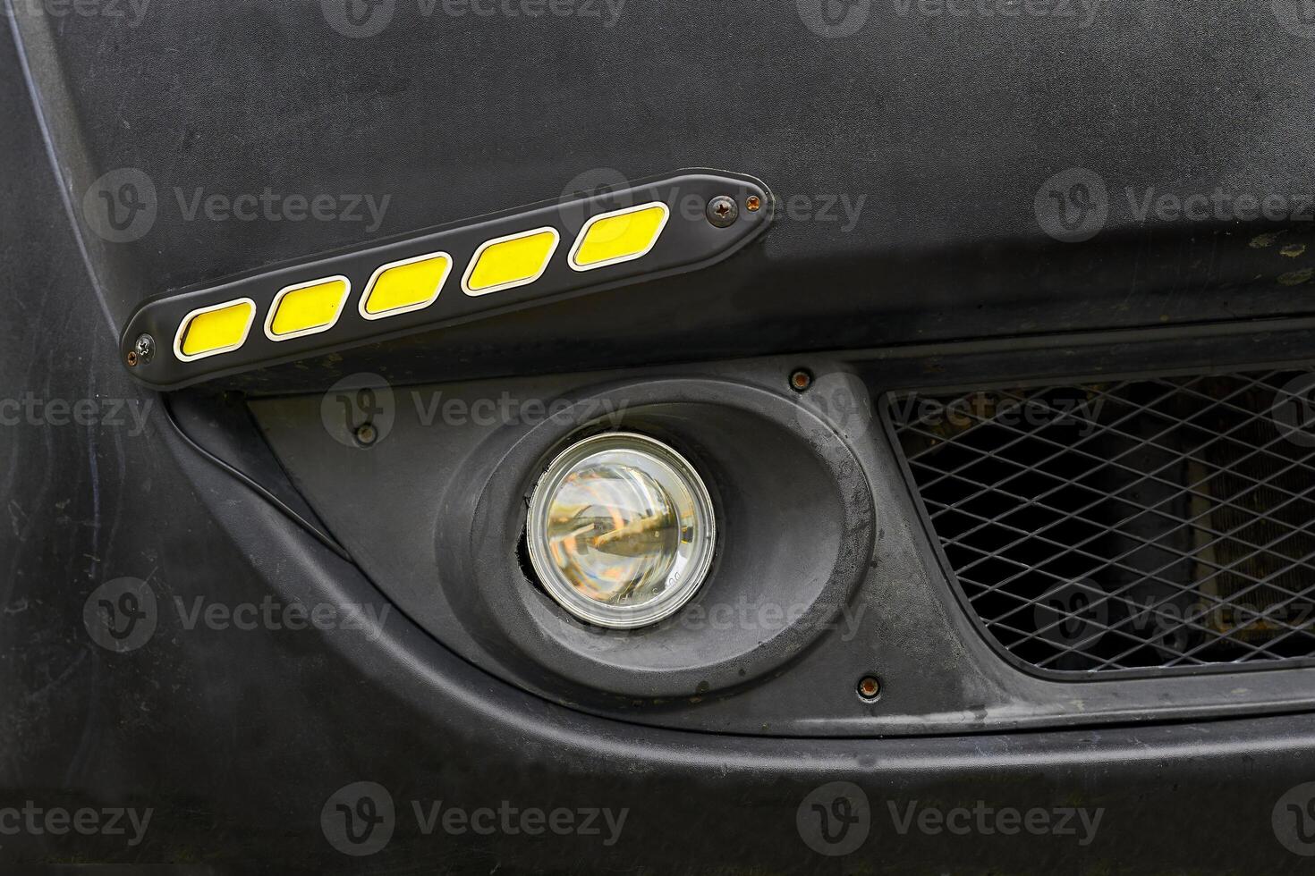 Fog light and LED side lights on black bumper photo