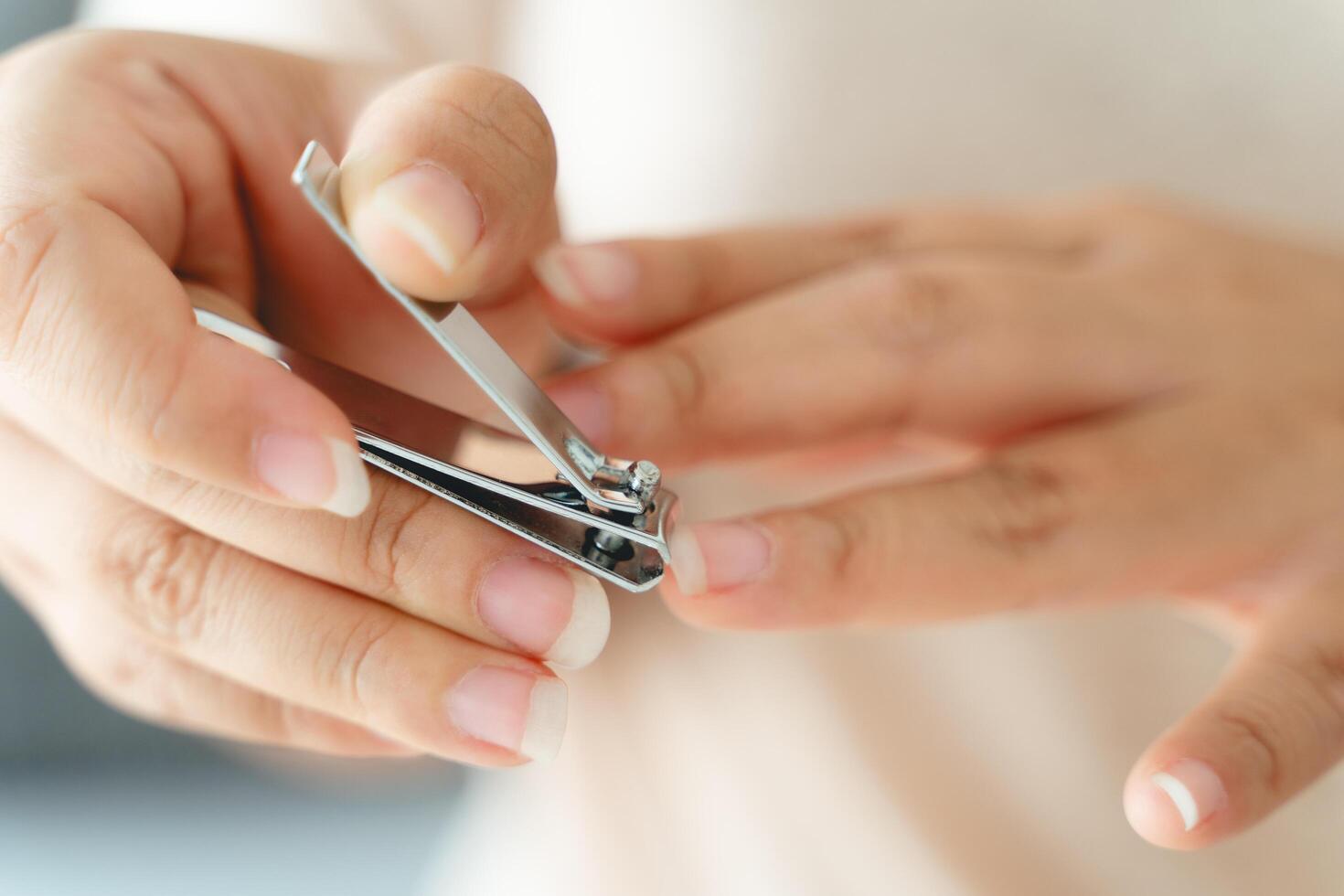 A woman is holding a pair of nail clippers photo