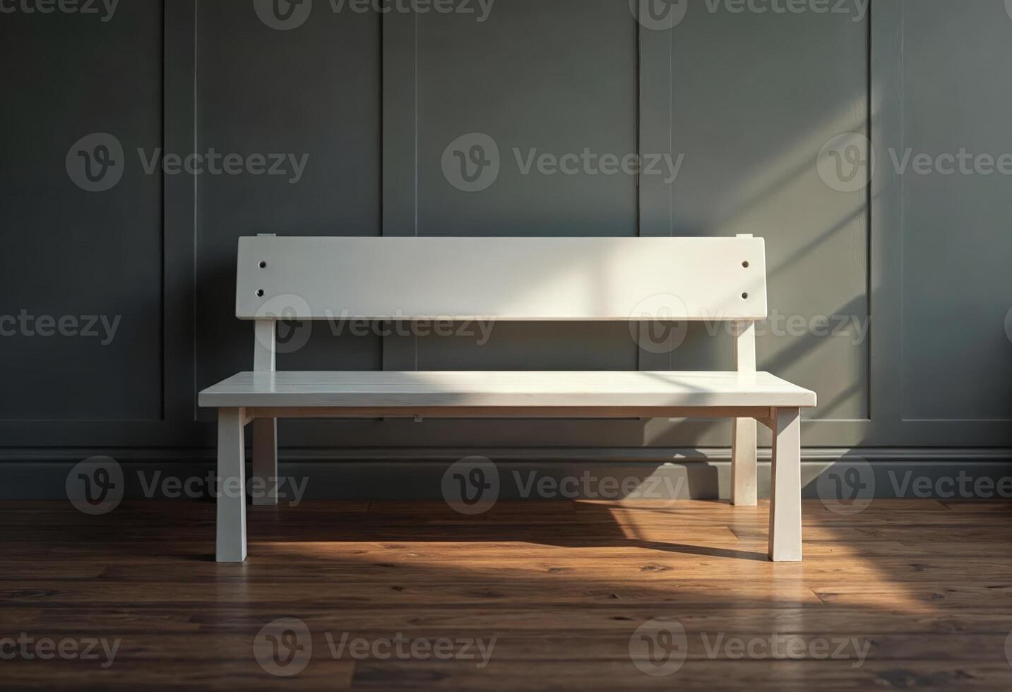 Empty white bench against a dark paneled wall with sunlight streaming in. photo