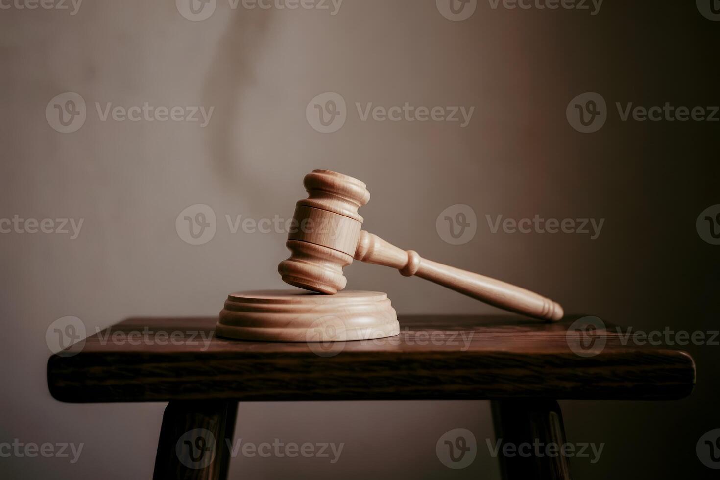 Wooden gavel and block on a wooden table, symbolizing justice and law. photo