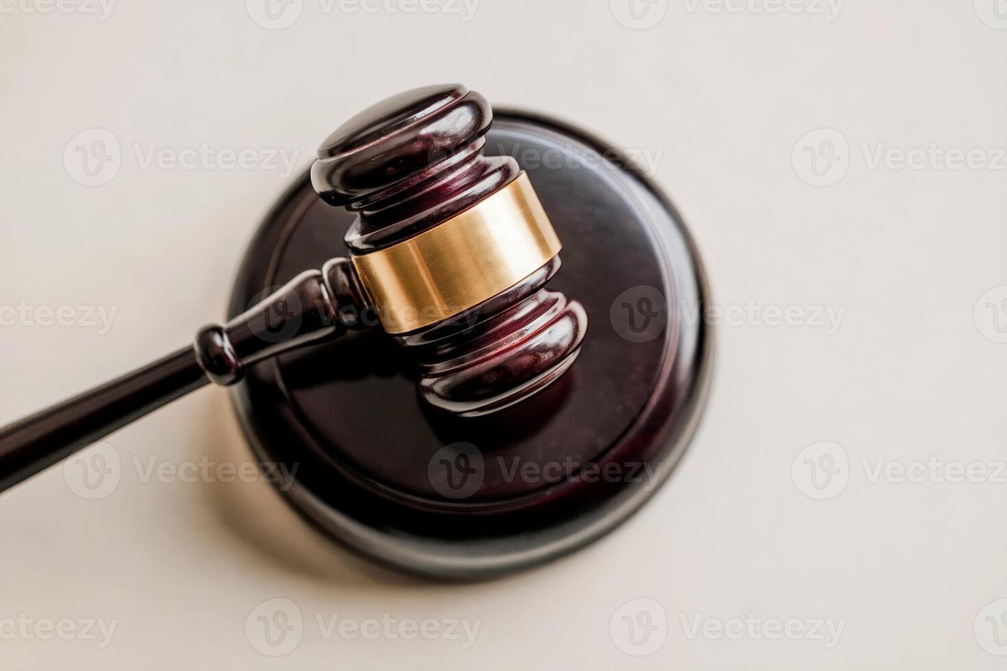 Wooden judge's gavel on a sound block in a courtroom setting. photo