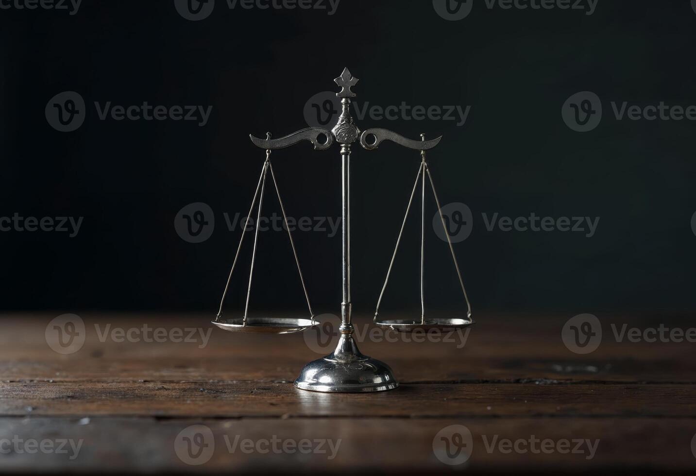 A balanced scale on a wooden surface against a dark background. photo