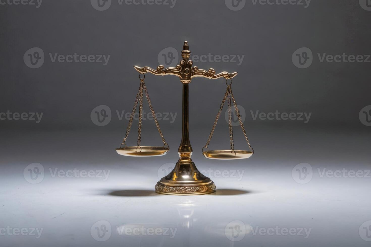 Golden balance scale on a reflective surface under studio lighting. photo