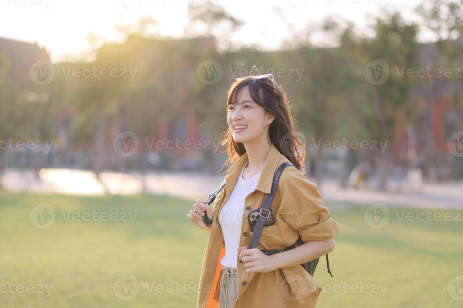 Traveler asian woman in her 30s stands bathed in the golden glow of sunset, embracing the freedom of exploration. on summer holiday weekend vacation trip in Bangkok, Thailand photo