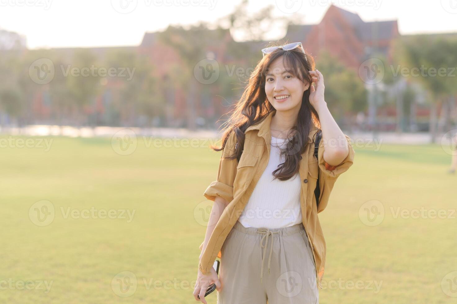Traveler asian woman in her 30s stands bathed in the golden glow of sunset, embracing the freedom of exploration. on summer holiday weekend vacation trip in Bangkok, Thailand photo