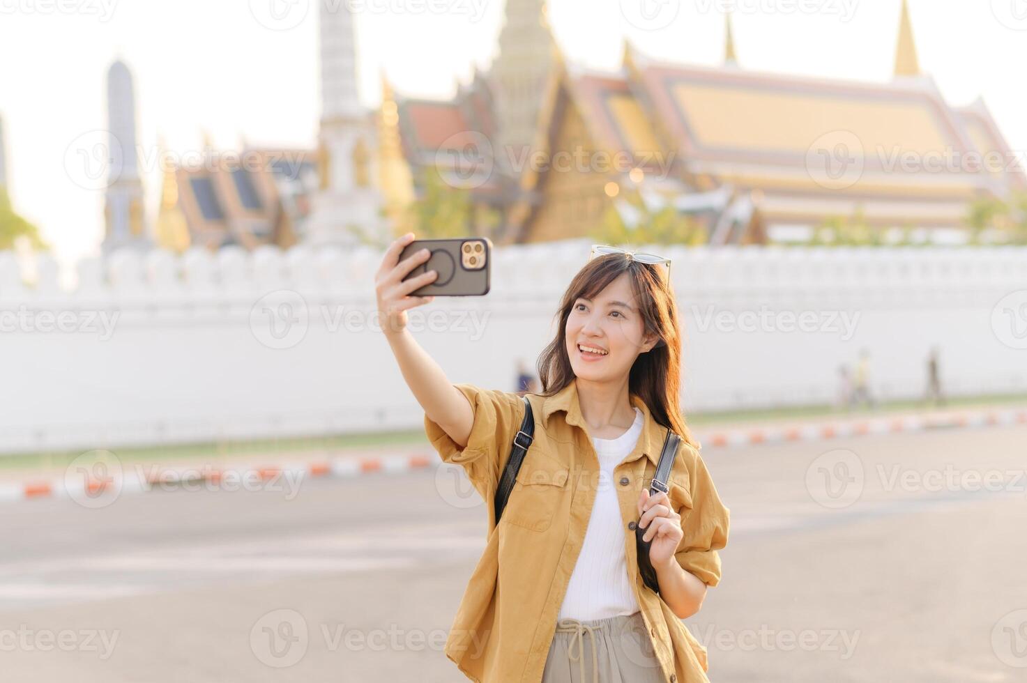 Traveler asian woman in her 30s explores the Grand Palace with a local guide. Uncover hidden gems and immerse yourself in Thai culture with her adventure. photo