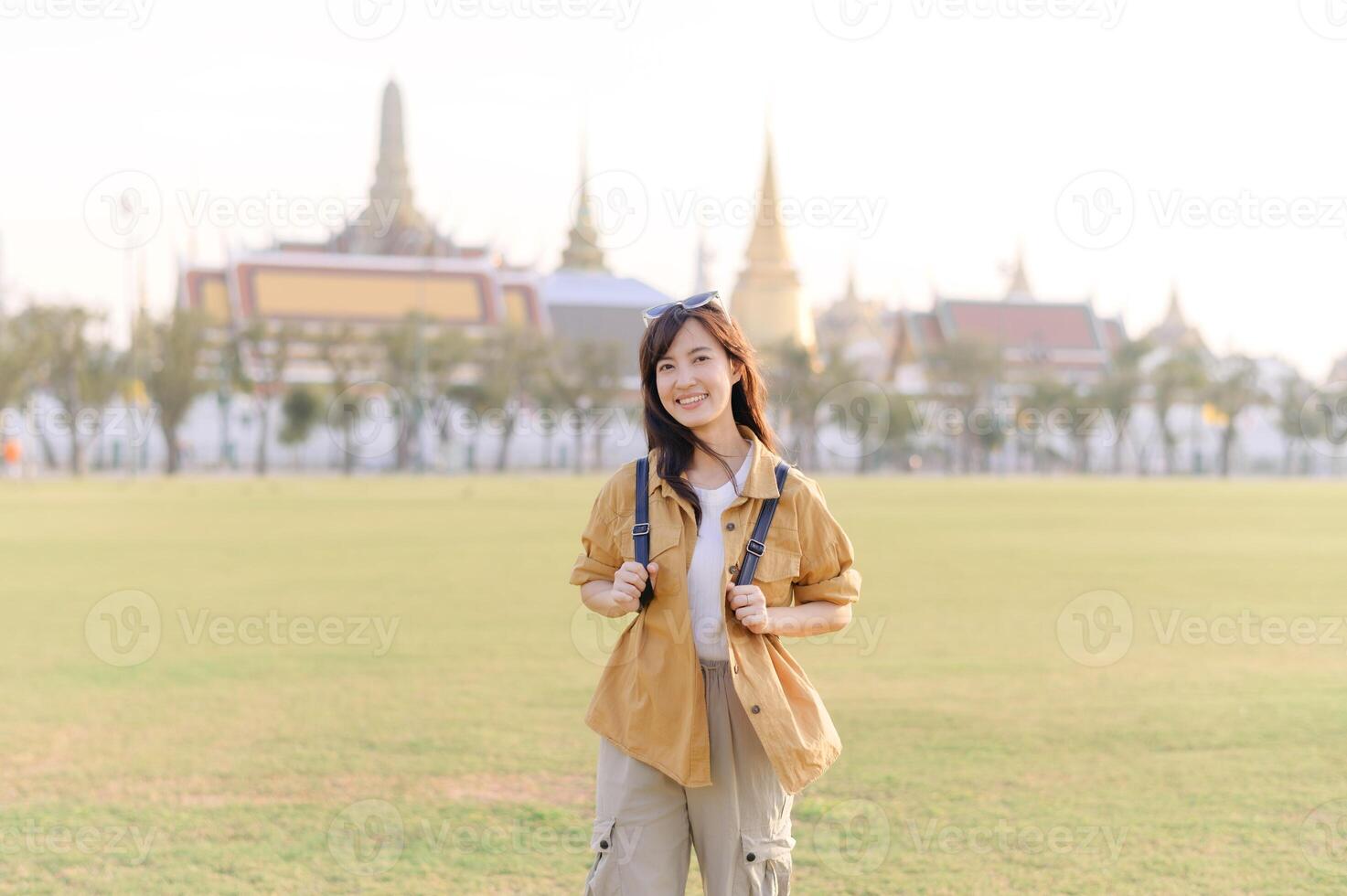 A Traveler Asian woman in her 30s exploring Wat Pra Kaew. From stunning architecture to friendly locals, she cherishes every moment, capturing it all in her heart and camera for years to come. photo