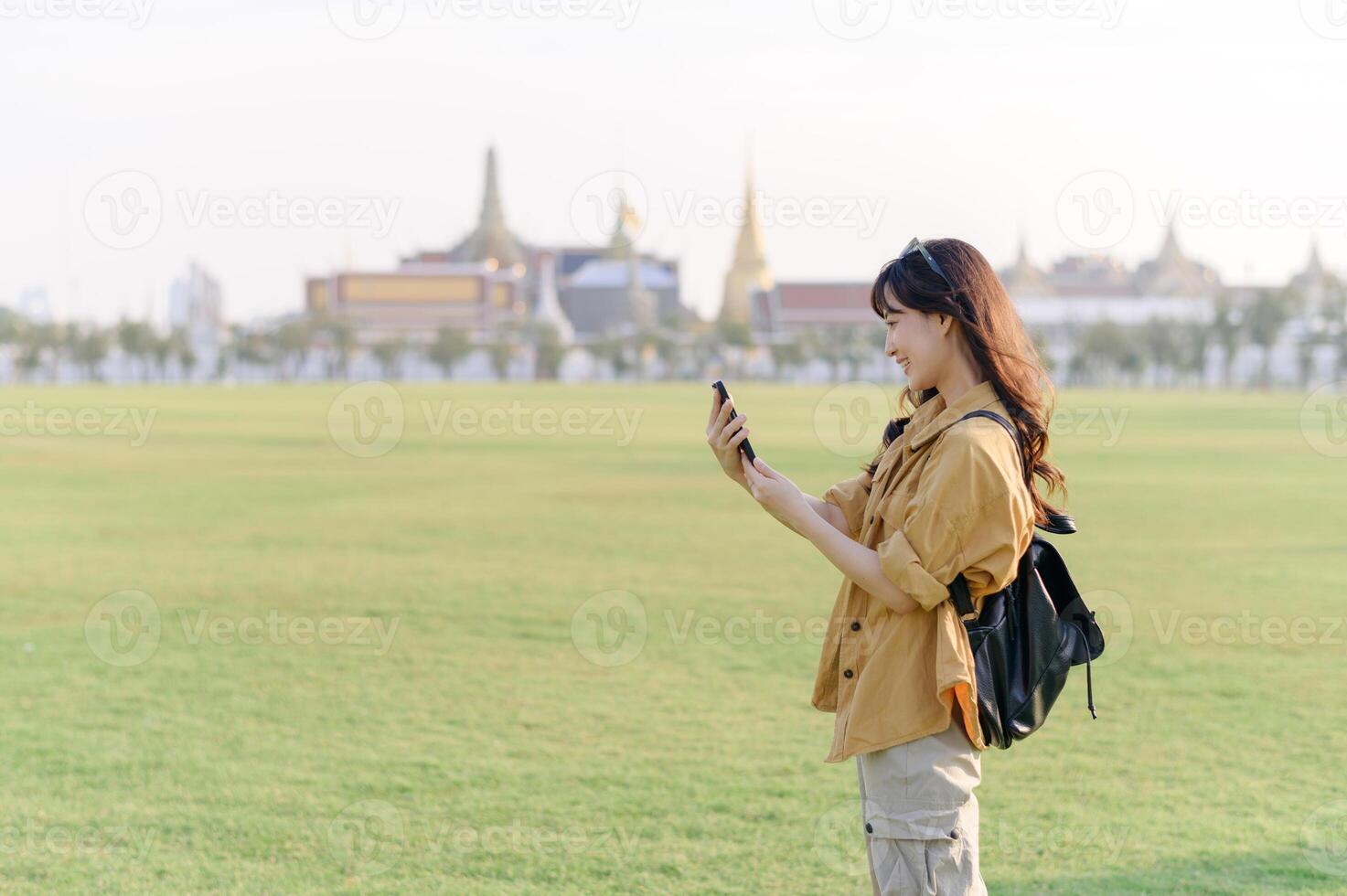 Traveler asian woman in her 30s explores the Grand Palace complex. This photo embodies the fascination with Thai culture and heritage.