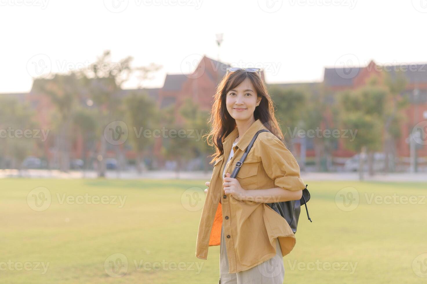 Traveler asian woman in her 30s stands bathed in the golden glow of sunset, embracing the freedom of exploration. on summer holiday weekend vacation trip in Bangkok, Thailand photo