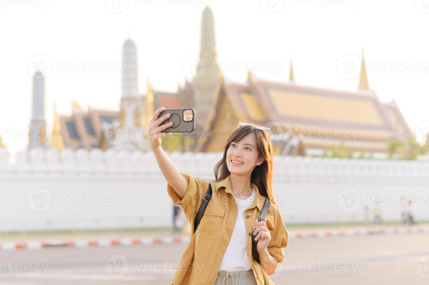 Traveler asian woman in her 30s explores the Grand Palace with a local guide. Uncover hidden gems and immerse yourself in Thai culture with her adventure. photo