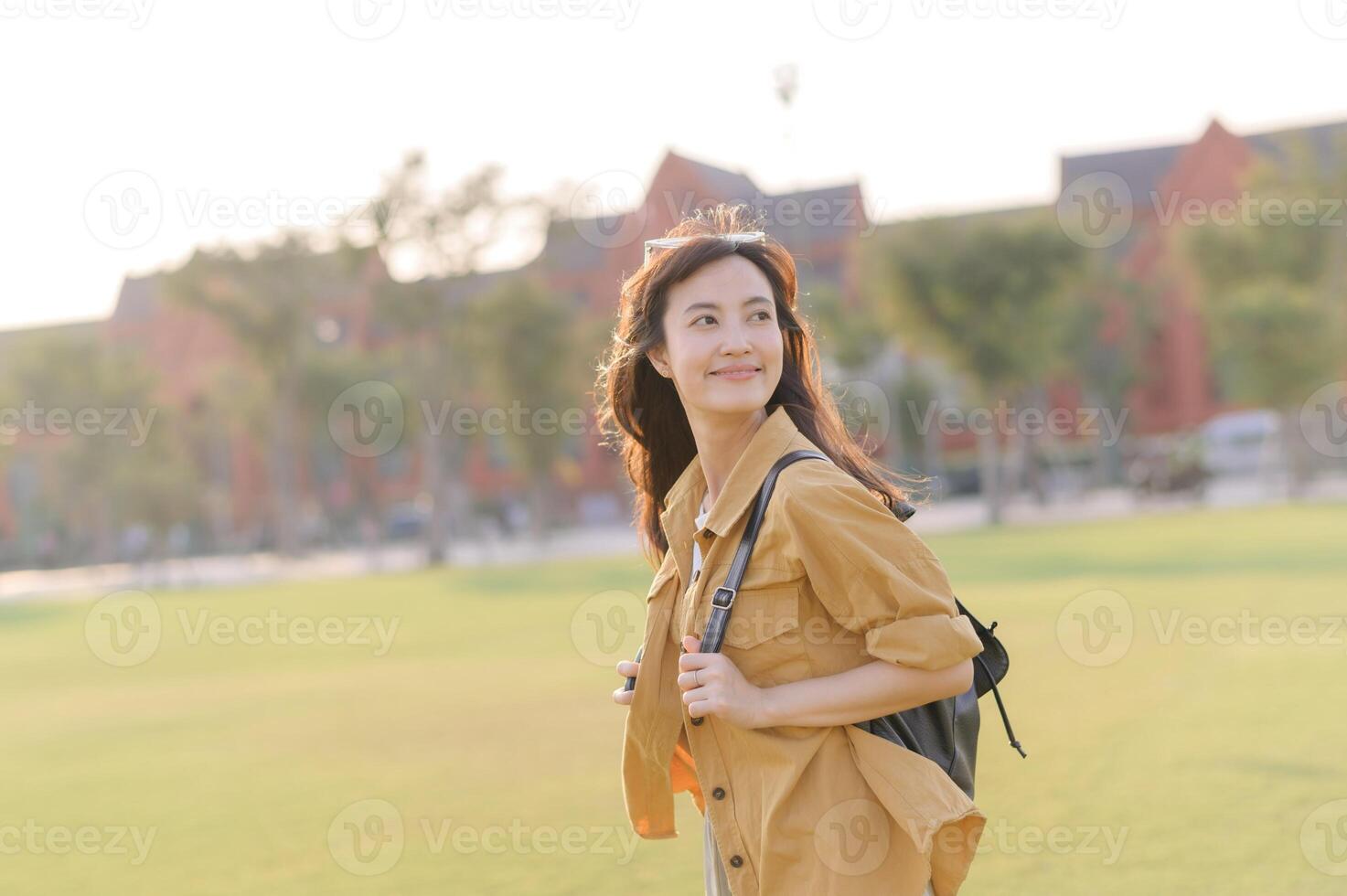Traveler asian woman in her 30s stands bathed in the golden glow of sunset, embracing the freedom of exploration. on summer holiday weekend vacation trip in Bangkok, Thailand photo