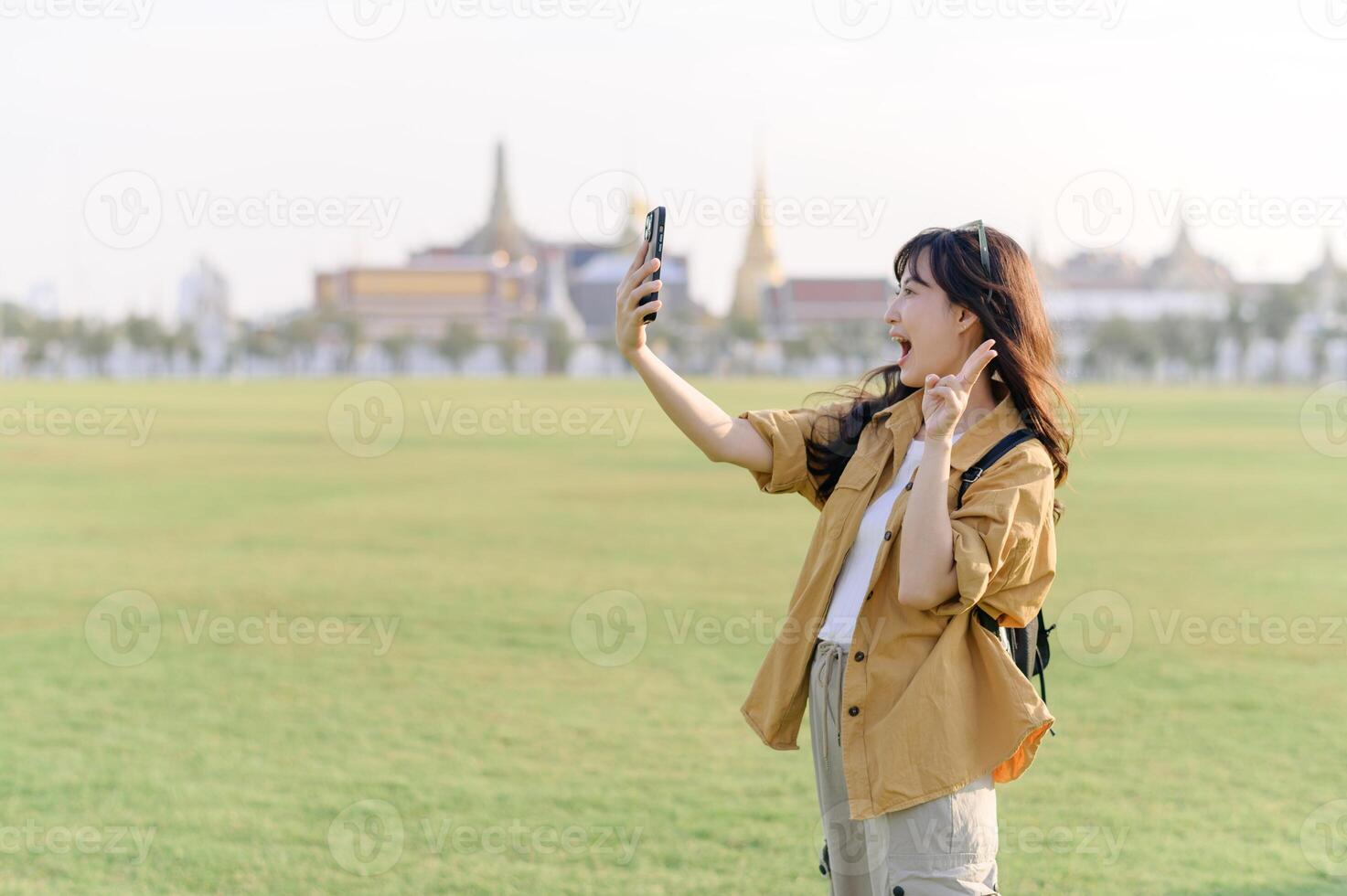 Traveler asian woman in her 30s explores the Grand Palace complex. This photo embodies the fascination with Thai culture and heritage.