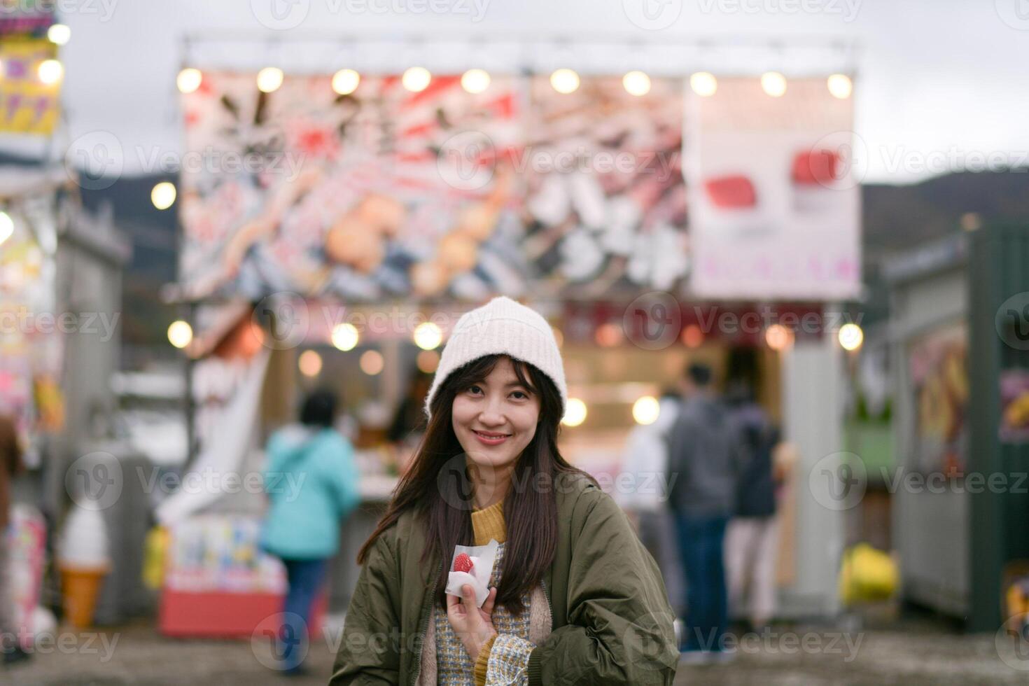 Japanese traveler enjoys a tasty strawberry treat in Tokyo during the sakura festival. A happy portrait capturing the essence of March in Japan. photo