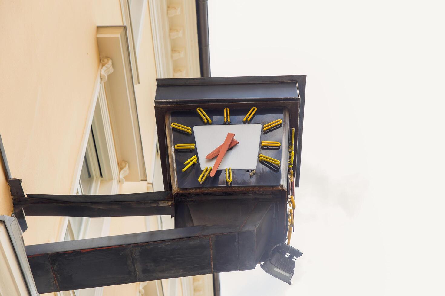 Vintage clock against building facade, urban architecture, timekeeping element, street view, outdoor, city life concept photo