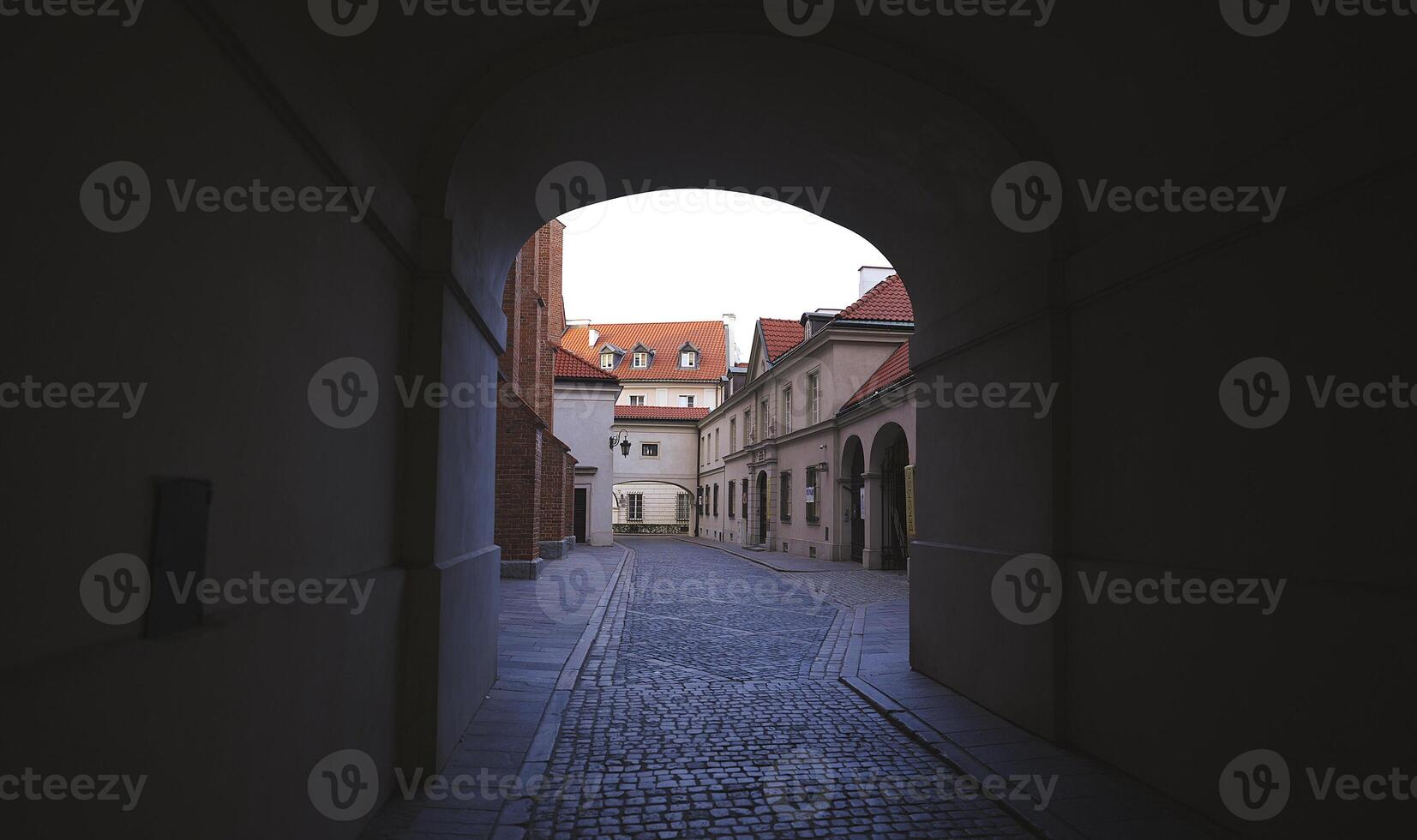 Quiet Elegance in Warsaw. Archway Framing Historic Structures, Empty Streets photo