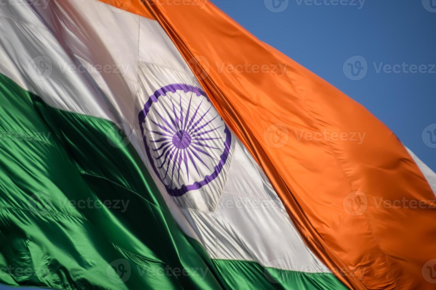 India flag flying high at Connaught Place with pride in blue sky, India flag fluttering, Indian Flag on Independence Day and Republic Day of India, tilt up shot, Waving Indian flag, Har Ghar Tiranga photo